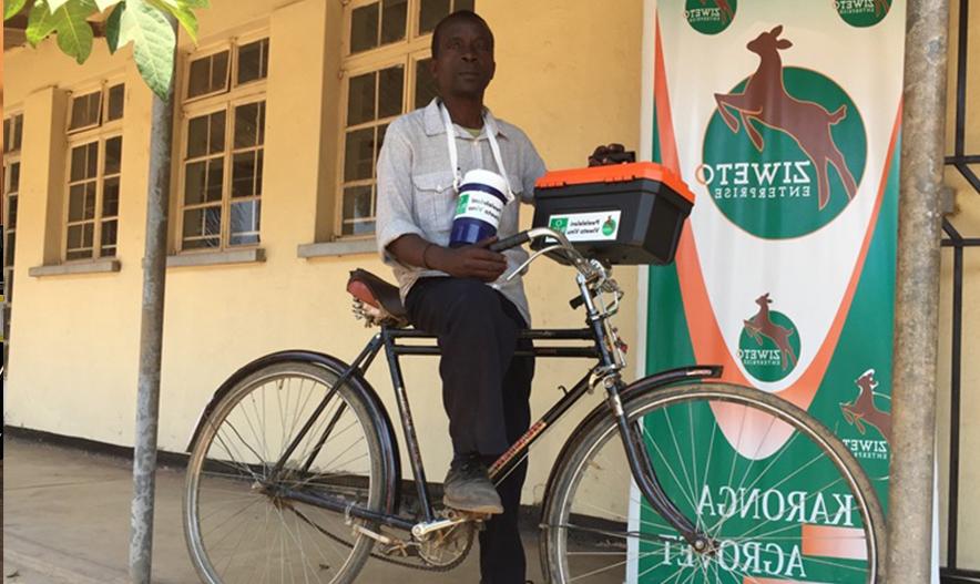 man on bike next to Ziweto sign